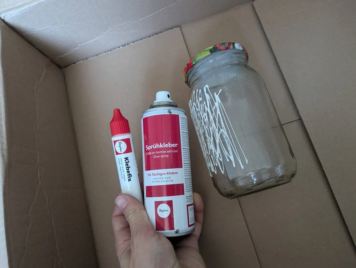 glass with half of it covered in Klebefix and the other half covered with spray-on glue